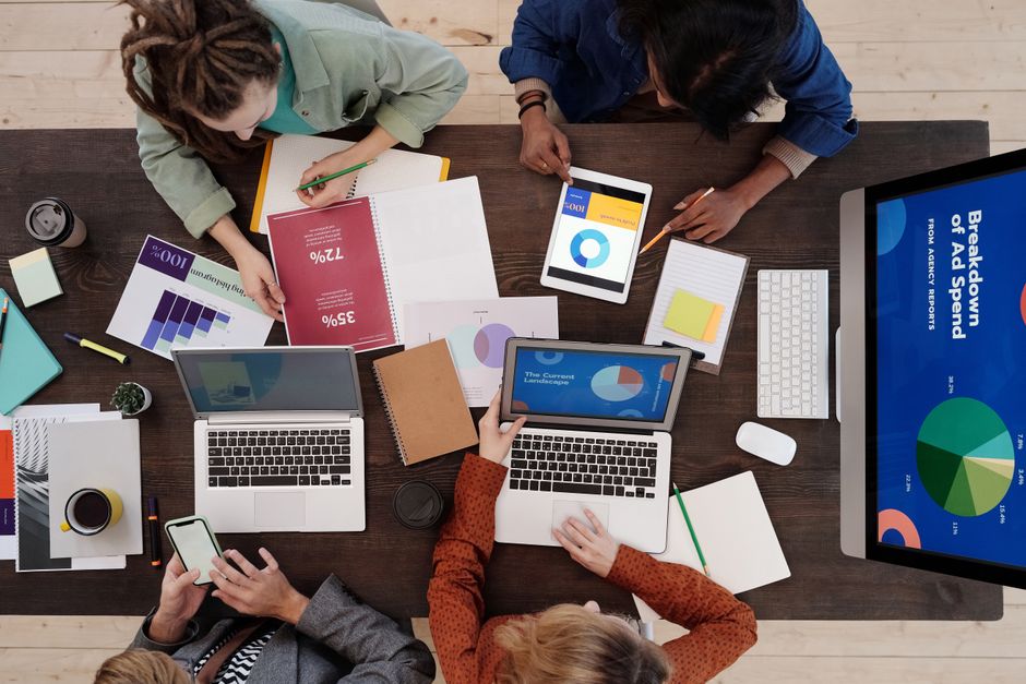 Professional marketing team planning content creation strategy on a laptop